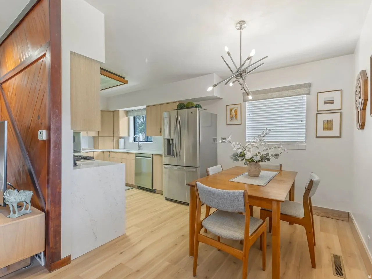 Kitchen featuring light wood-finish cabinetry, stainless steel appliances, and light-toned countertops