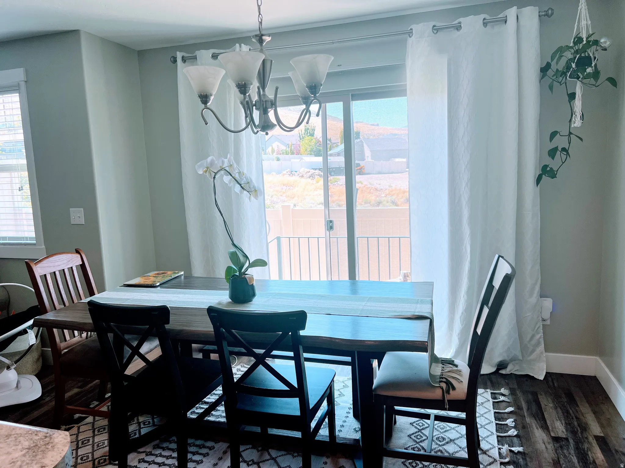 Dining area featuring wood-finish flooring and a contemporary chandelier