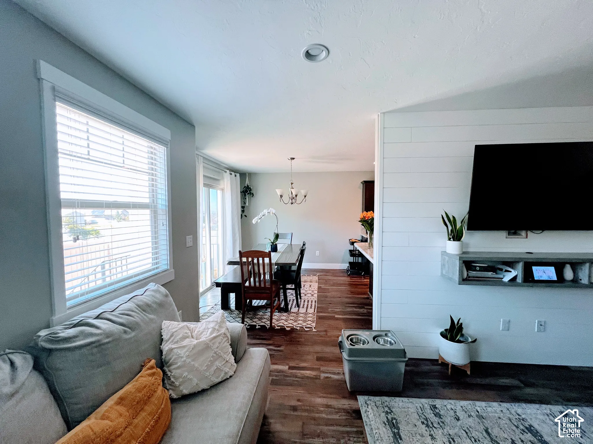 Wood-finish flooring throughout, with a shiplap accent wall and recessed ceiling lighting