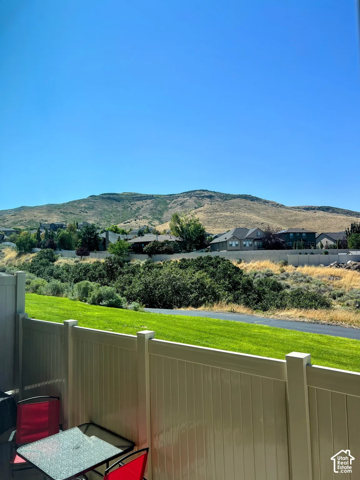 Mountain backdrop with visible residences and a clear sky