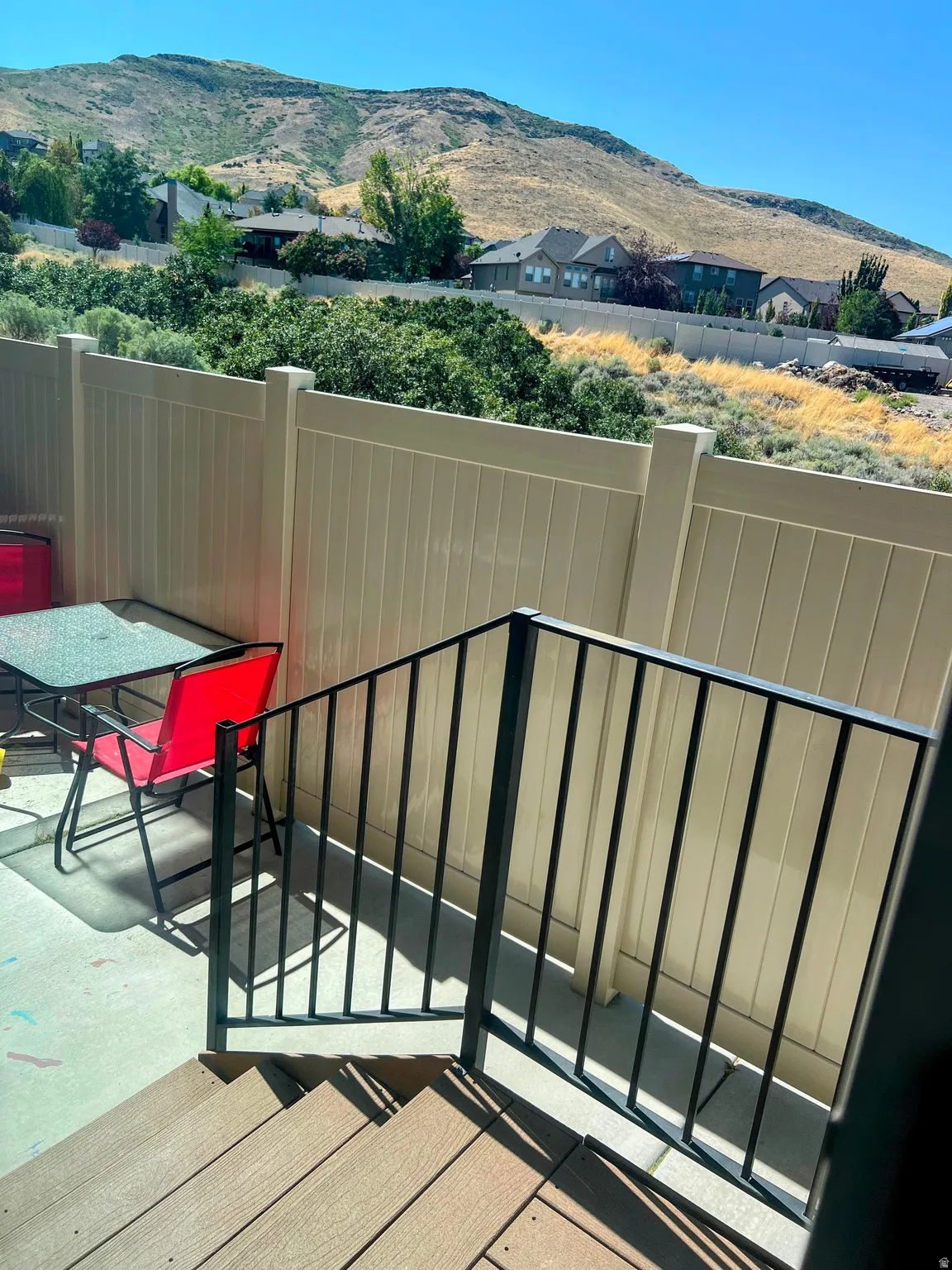 Composite deck stairs with black metal railings