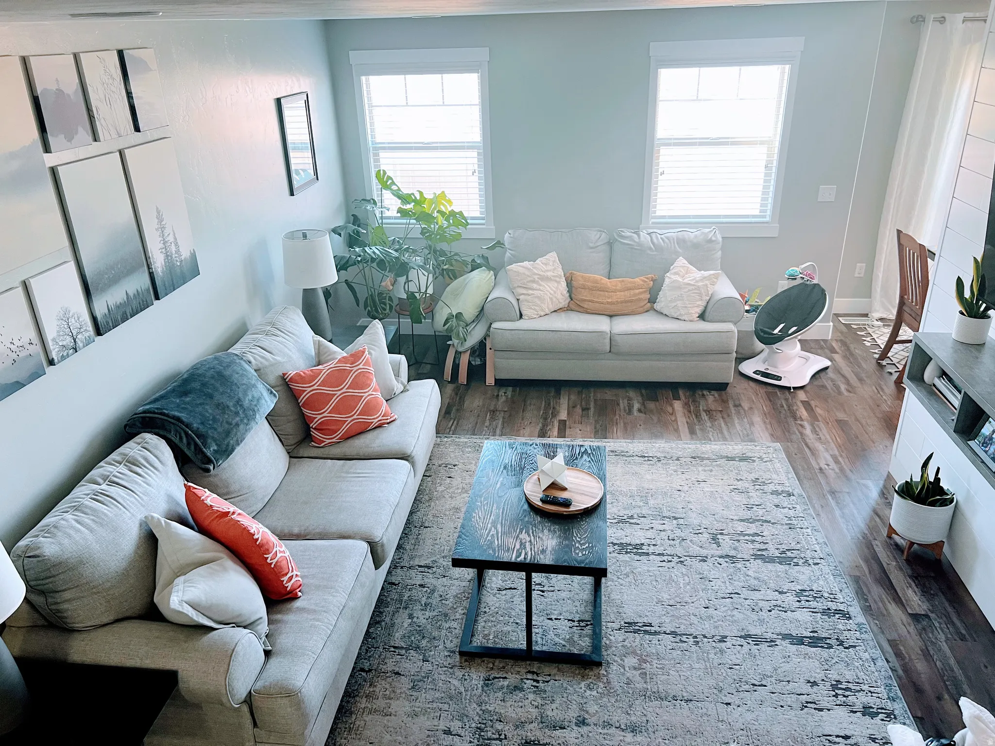 Recessed lighting, wood-finish flooring, and white window blinds