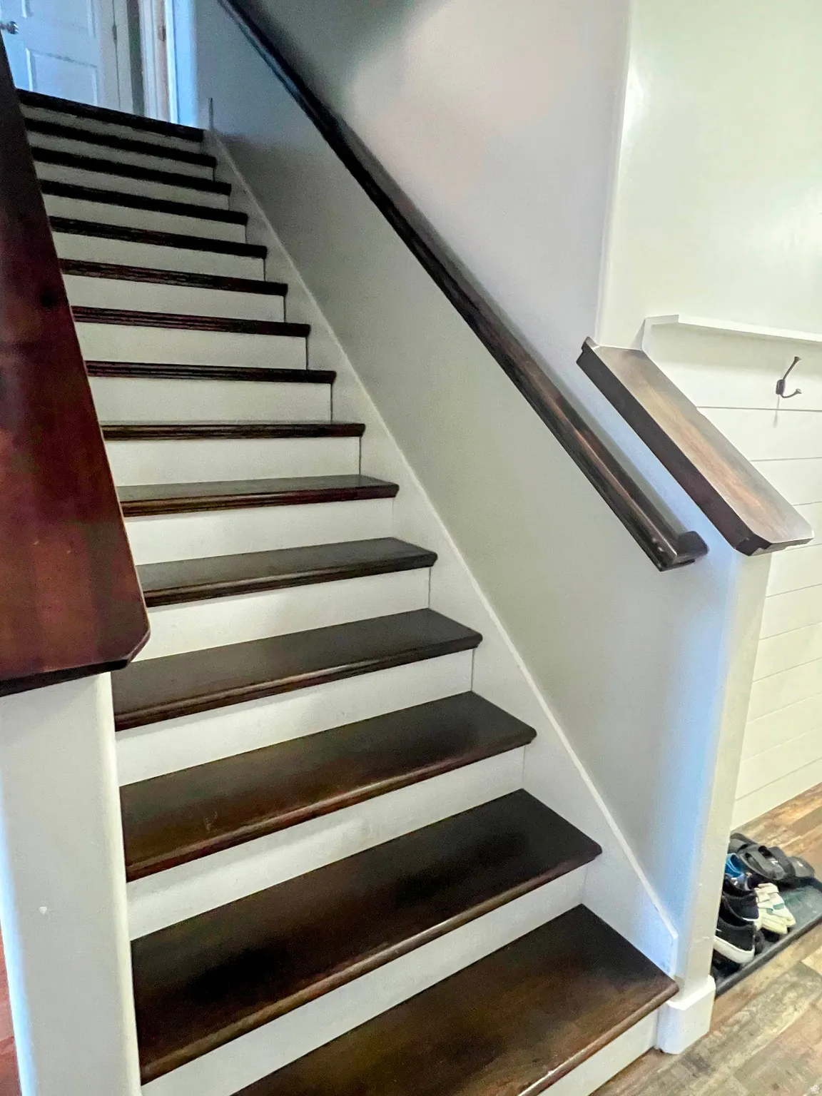 Staircase featuring dark wood-finish treads and risers