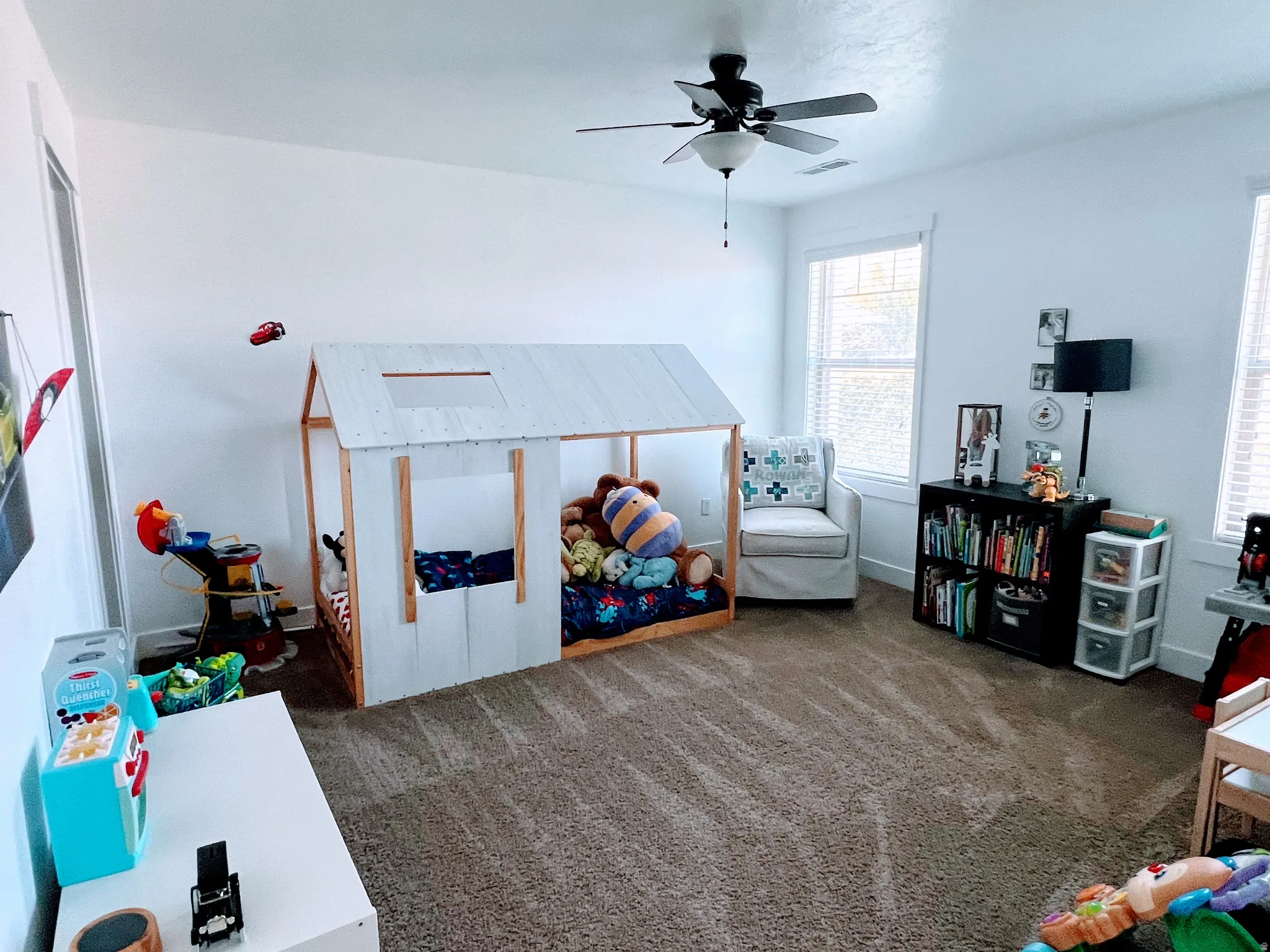 Wall-to-wall carpeting with light-colored walls and multiple windows