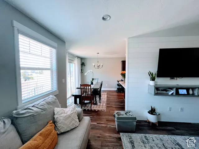 Wood-finish flooring throughout, with a shiplap accent wall and recessed ceiling lighting