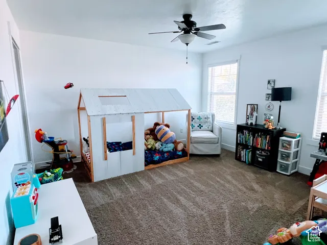 Wall-to-wall carpeting with light-colored walls and multiple windows