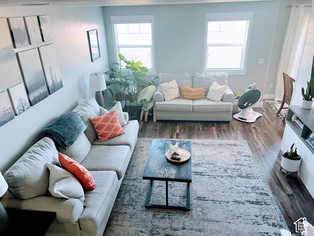 Recessed lighting, wood-finish flooring, and white window blinds