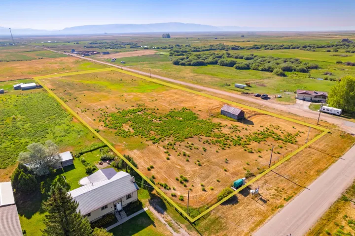 Expansive land parcel featuring a barn structure and perimeter fencing