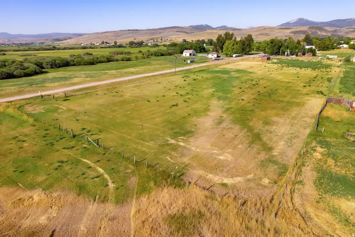 Expansive land offering a clear parcel, perimeter fencing, and distant mountain scenery