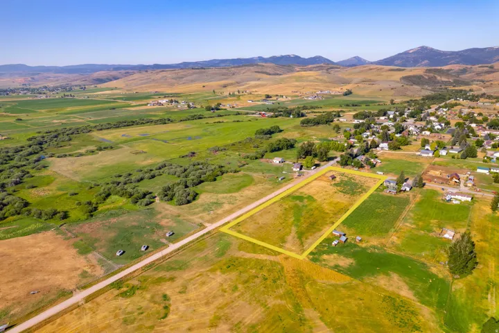 Expansive lot with surrounding rural properties and distant mountainous terrain