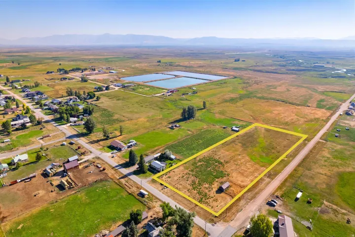 Expansive land parcel with surrounding agricultural fields and a distinct mountain backdrop