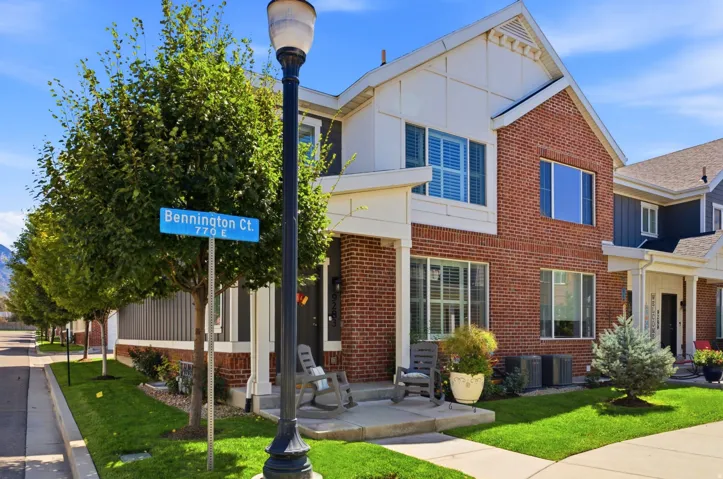 Brick exterior with white siding accents and a pitched roofline