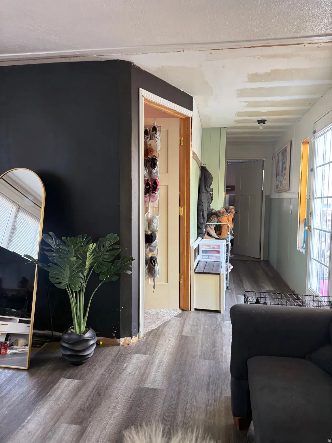 Wood-finish flooring throughout, solid core doors, and recessed lighting in the hallway