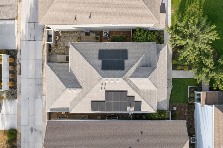 Pitched shingle roof with multiple solar panel arrays