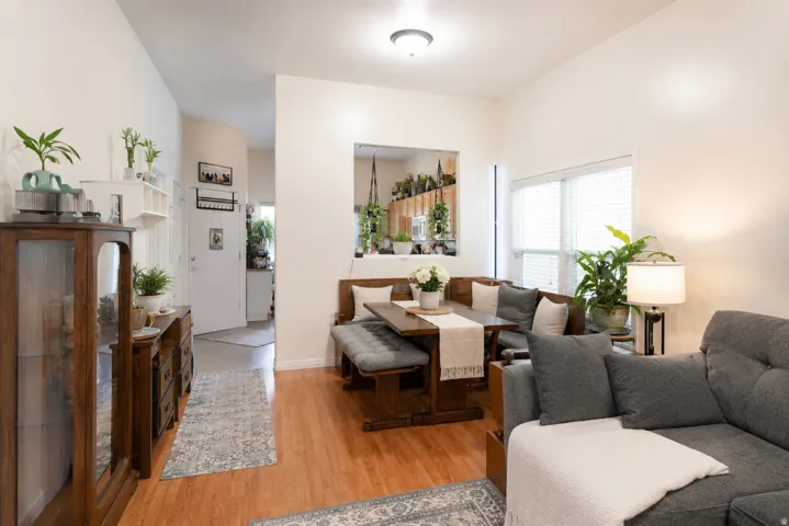 Hardwood-finish flooring throughout, bright white walls, and a built-in dining bench