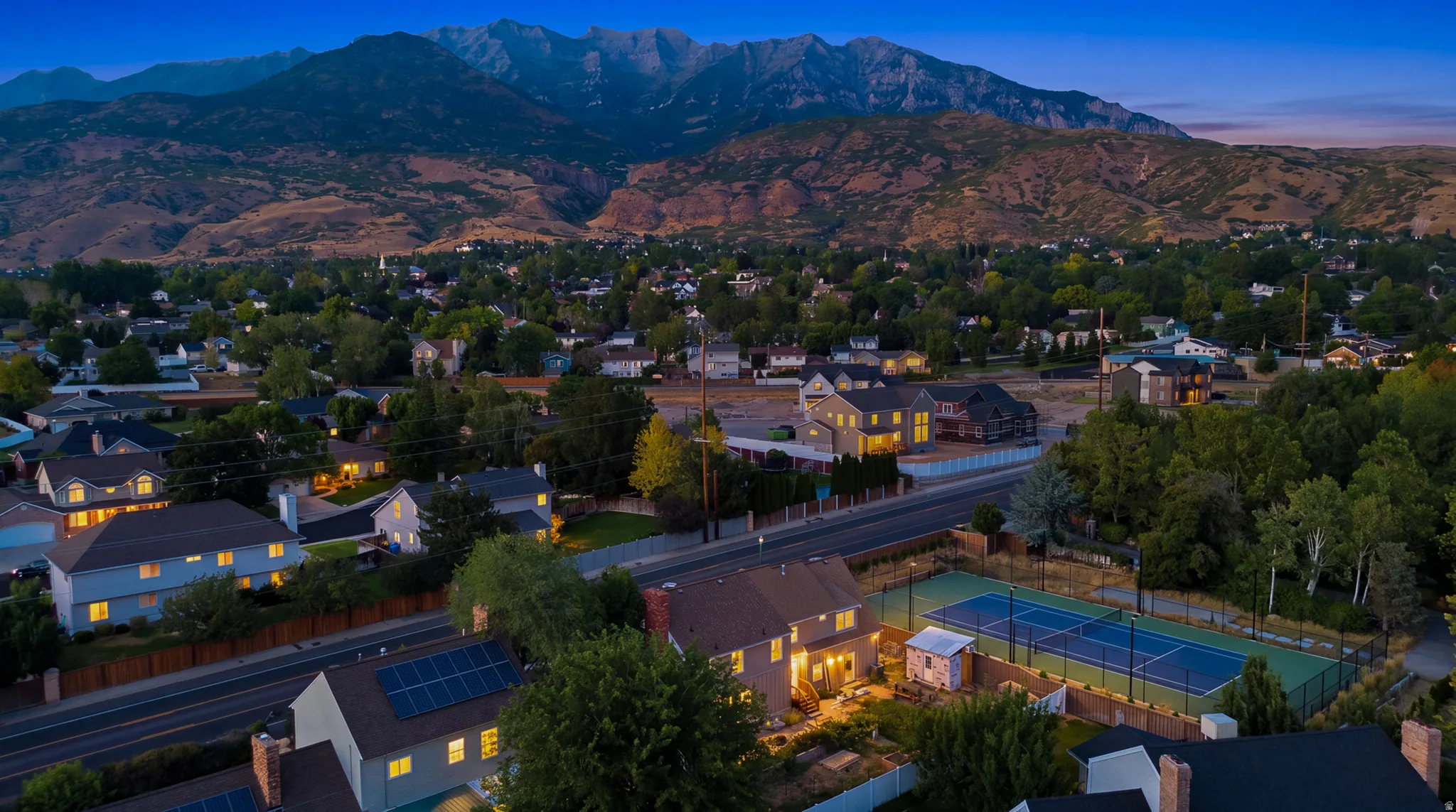 Aerial perspective of a neighborhood with mountain backdrop