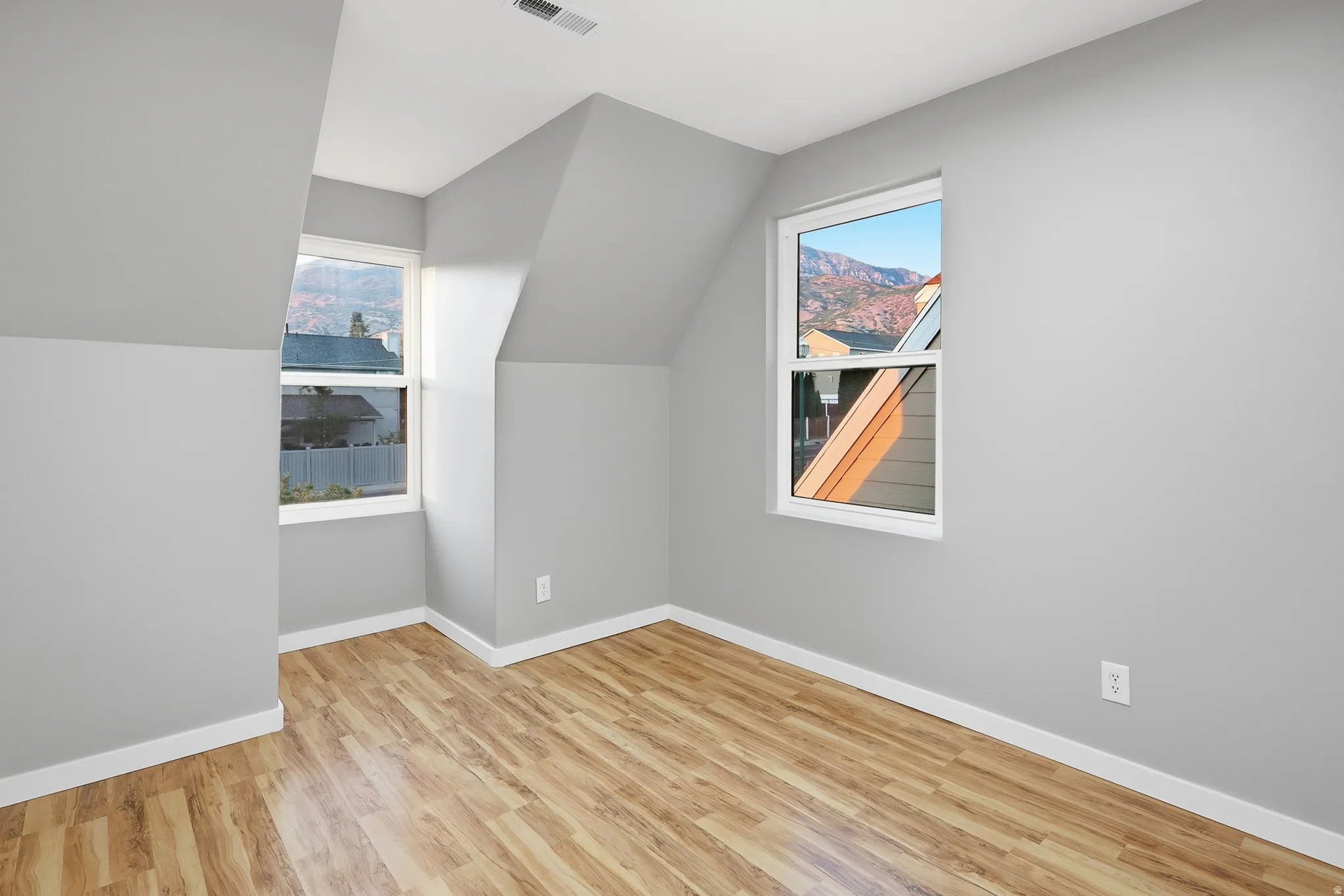 Light gray wall finish with wood-finish flooring