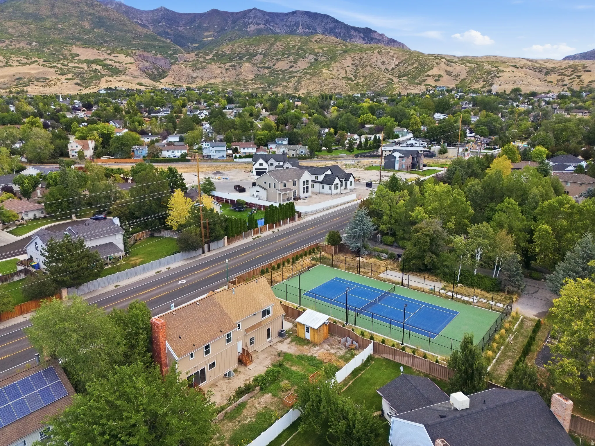 Property with tennis courts, adjacent to a paved road