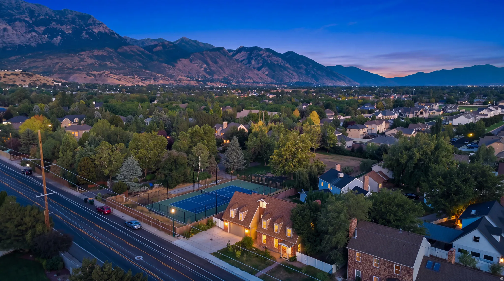 Aerial perspective showcasing a residential neighborhood with a prominent mountain backdrop