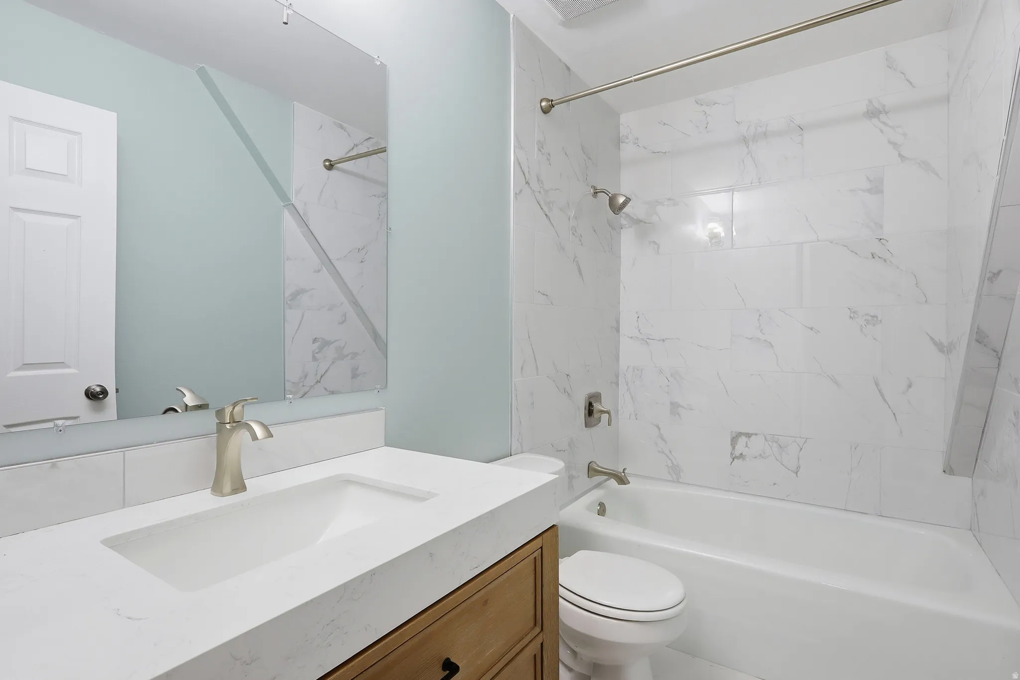 Bathroom featuring a built-in vanity with an integrated sink and brushed nickel faucet