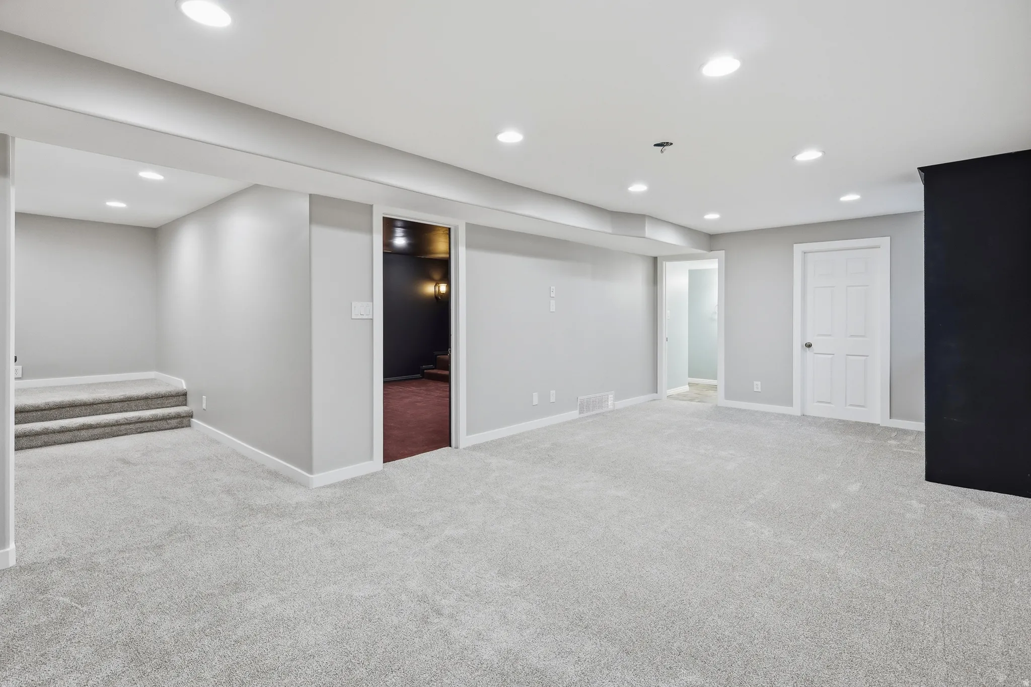 Recessed lighting, light gray carpet flooring, white trim, and white paneled doors