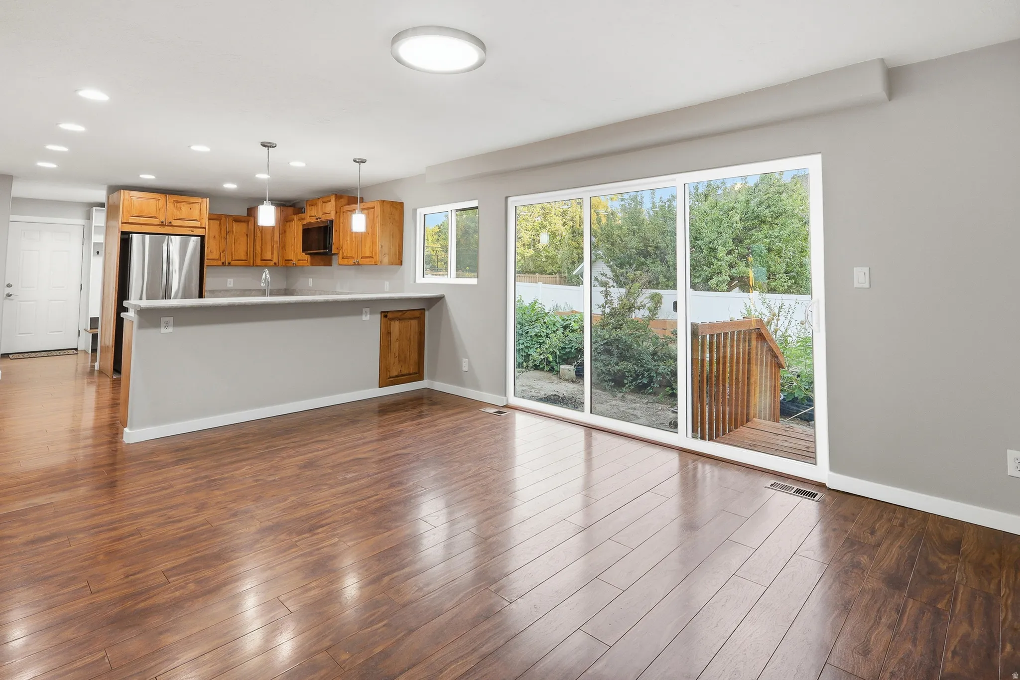Open-concept living space with wood-finish flooring