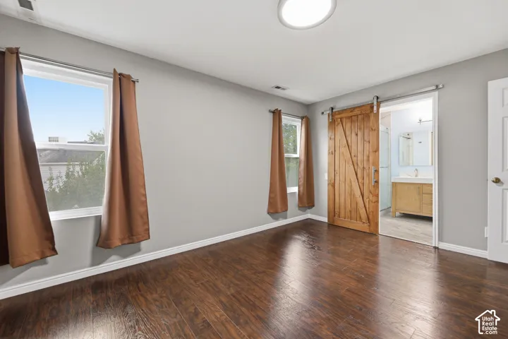 Wood-finish flooring, light gray walls, and a recessed ceiling light