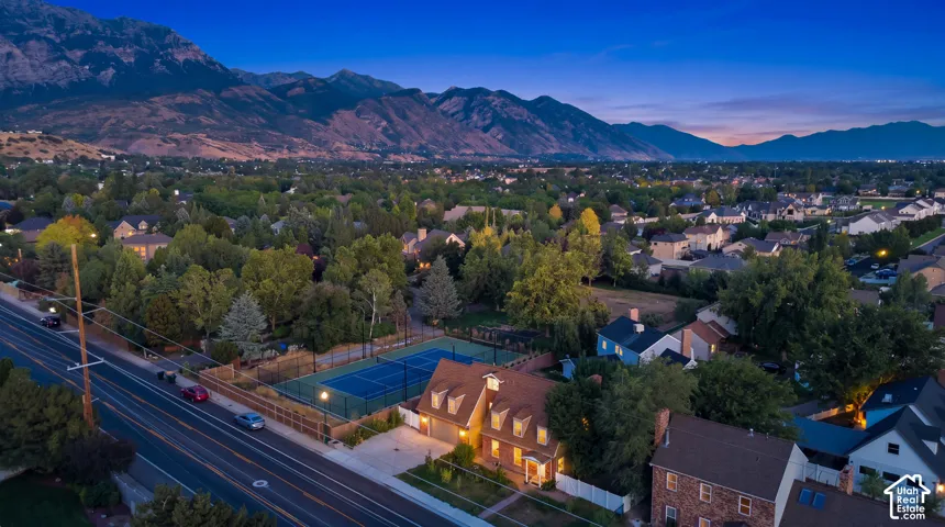 Aerial perspective showcasing a residential neighborhood with a prominent mountain backdrop
