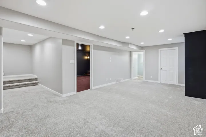 Recessed lighting, light gray carpet flooring, white trim, and white paneled doors