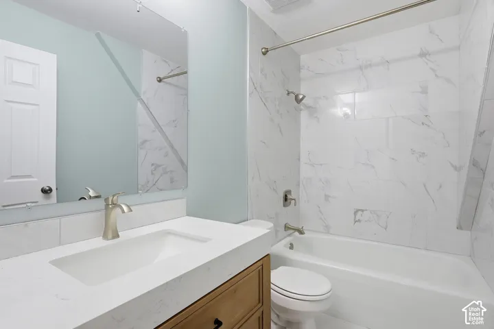 Bathroom featuring a built-in vanity with an integrated sink and brushed nickel faucet