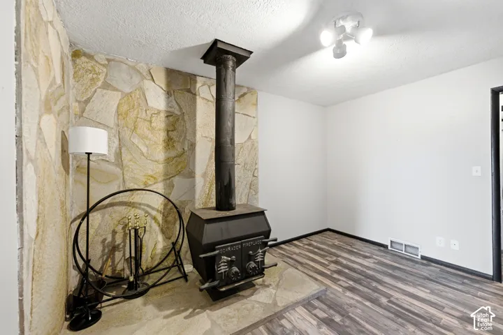 Stone-faced accent wall with a built-in wood-burning stove and hearth