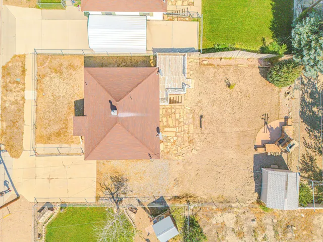 Pitched roof structure, concrete driveway, concrete patio, detached shed, wood deck