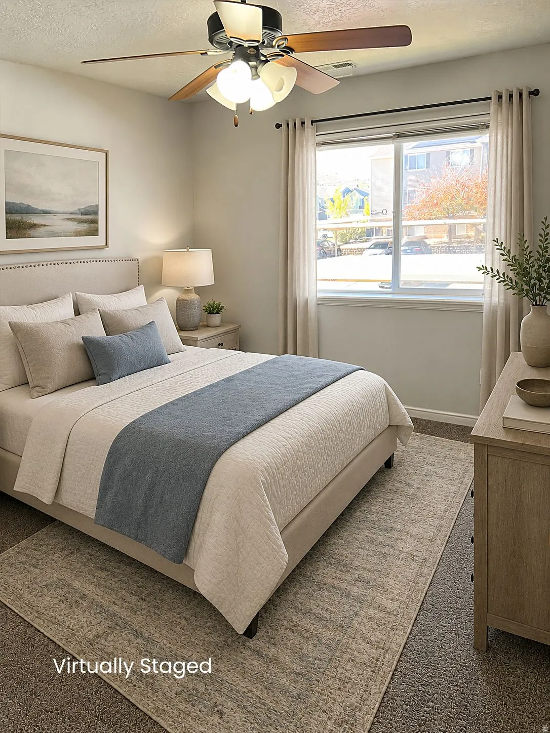 Spacious room with a ceiling fan, neutral wall paint, and a large window