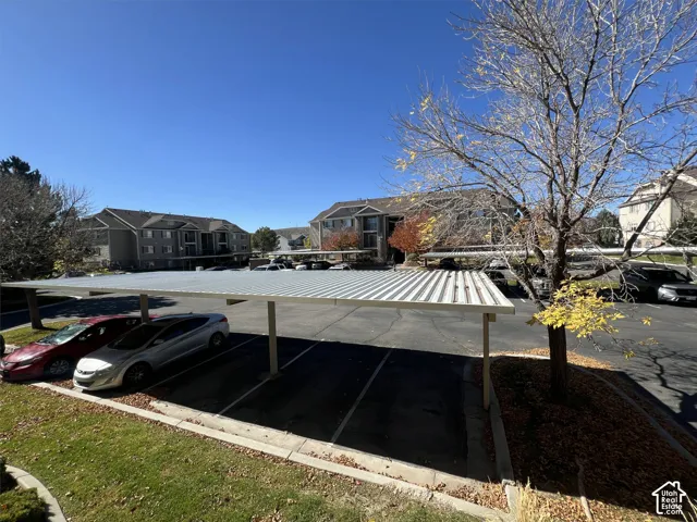 Covered parking structure with multiple spaces and adjacent green space