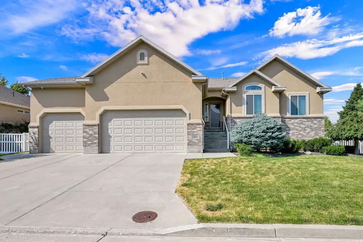Stucco exterior with stone accents and an arched window detail