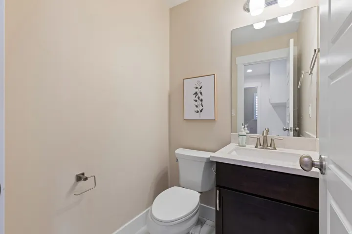 Vanity with dark wood-finish cabinetry, integrated sink, and brushed nickel faucet