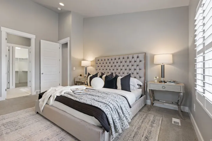 Plush carpet flooring, recessed lighting, white louvered window blinds, and a built-in closet system