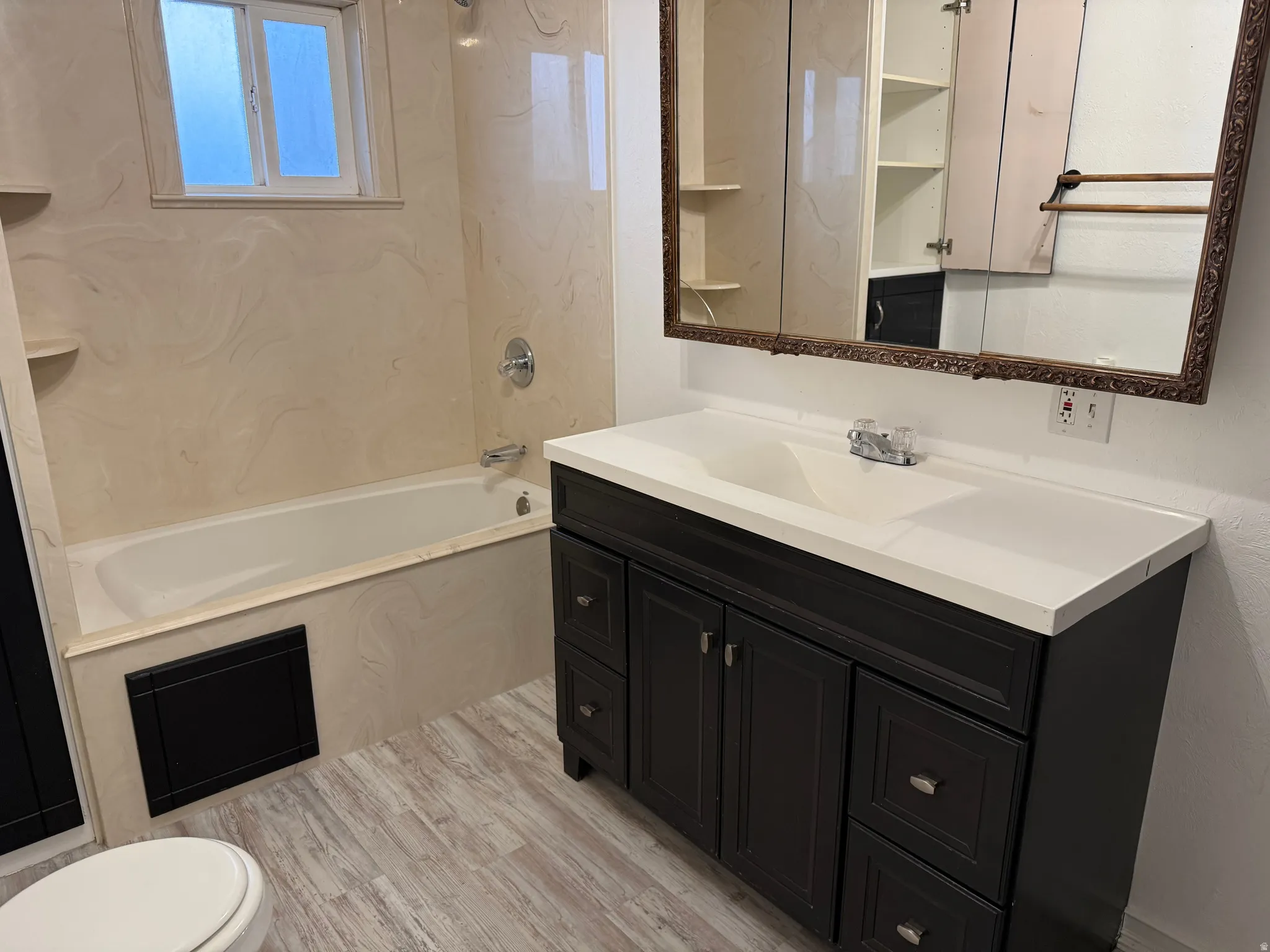 Dark wood-finish vanity with an integrated sink and white countertop