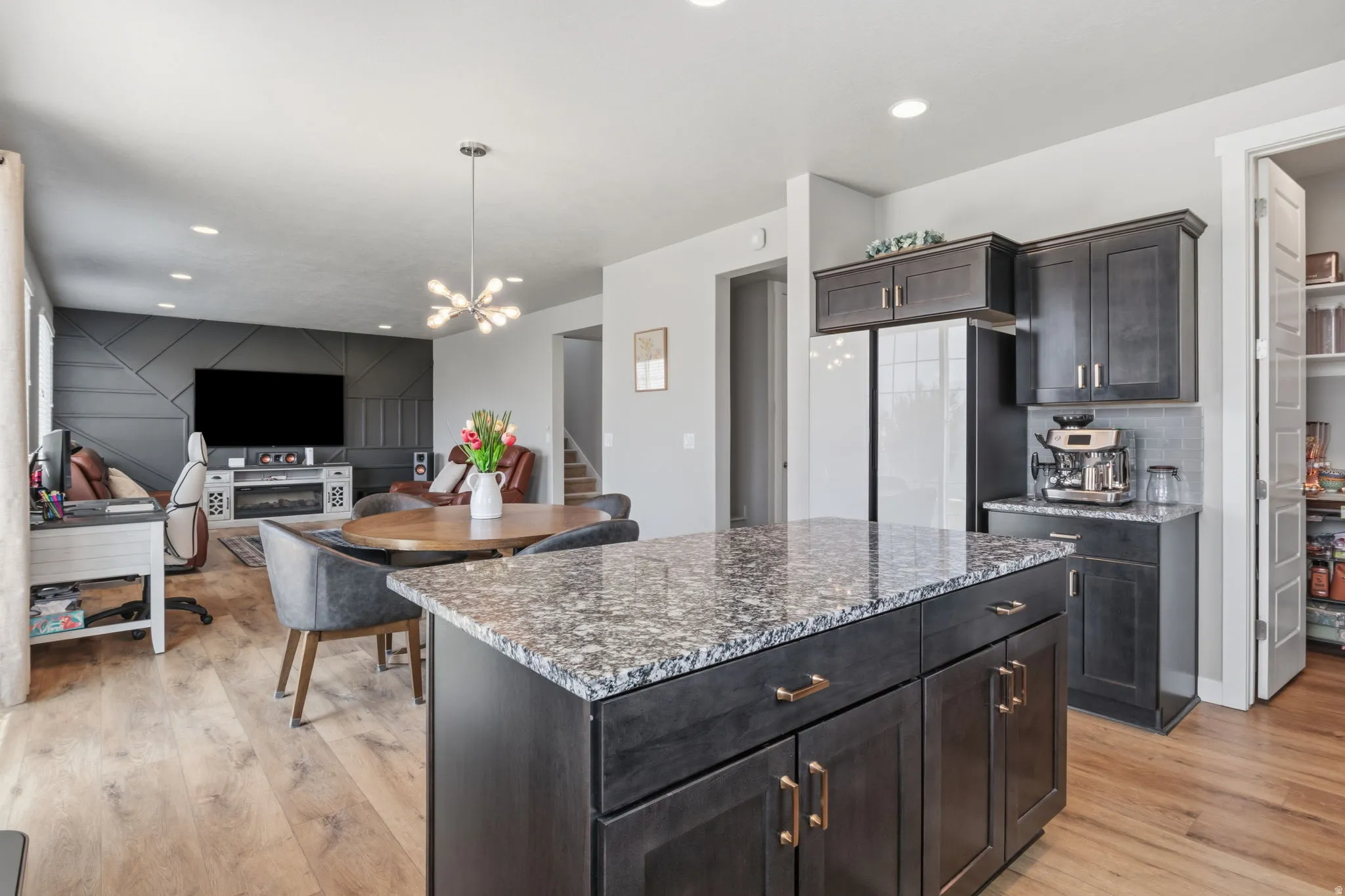 Kitchen island with granite countertop and dark wood cabinetry