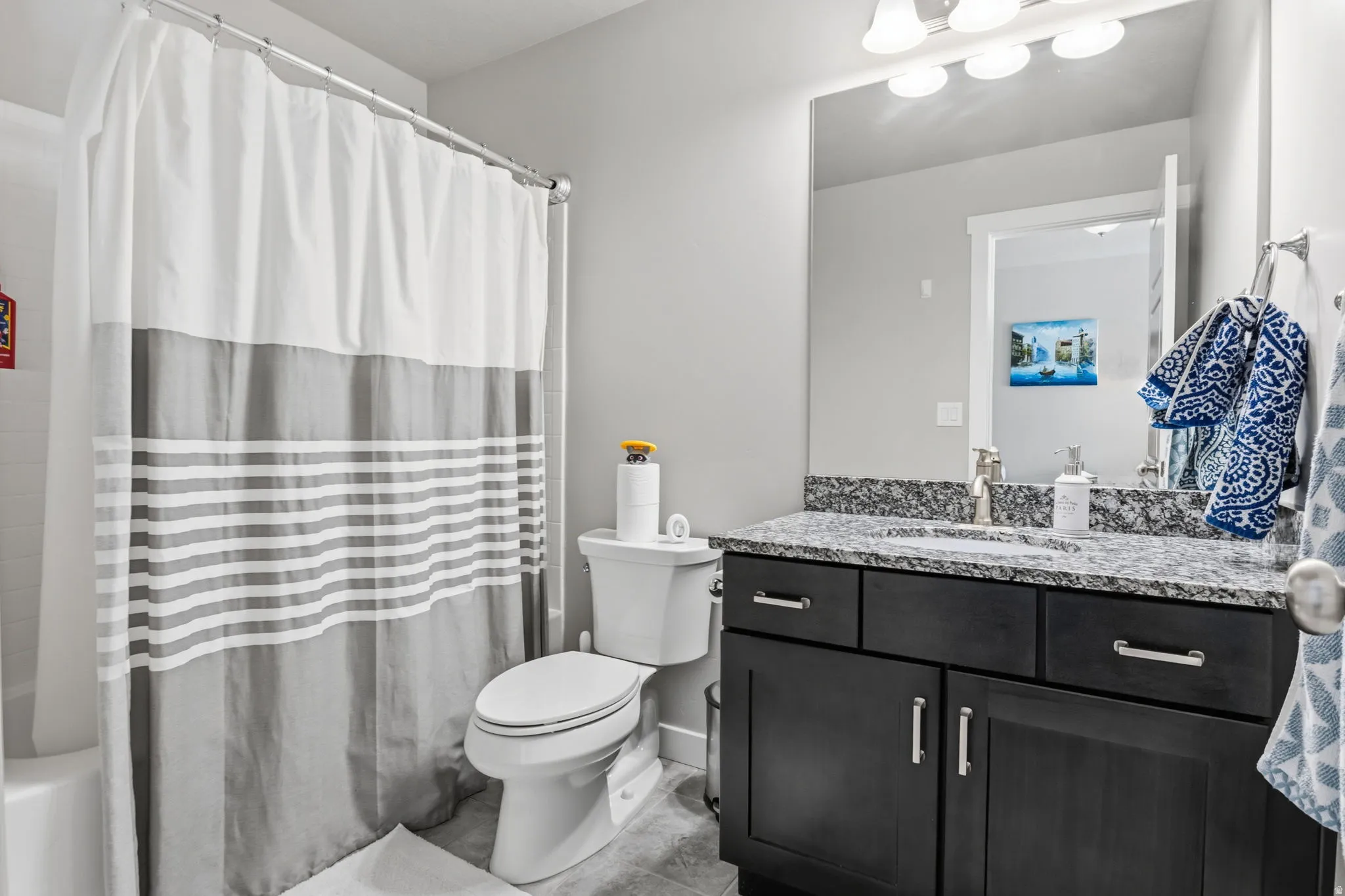 Dark wood-finish vanity with a stone-finish countertop