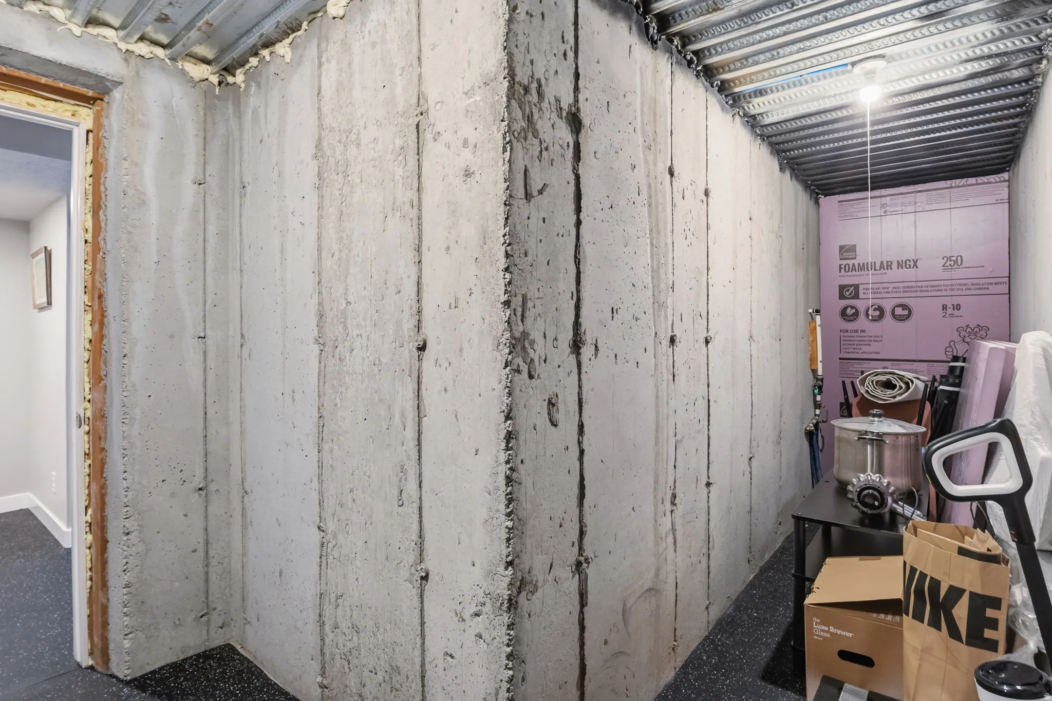 Exposed concrete walls and ceilings with an unfinished ceiling structure