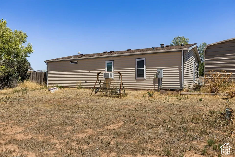 Exterior featuring horizontal siding, multiple windows, and a side-entry door
