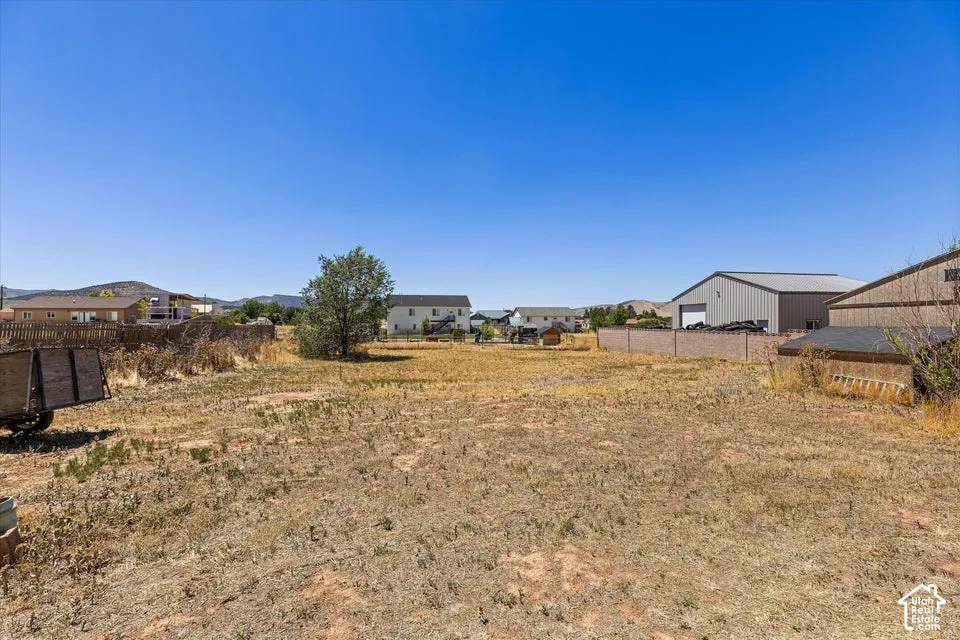 Expansive land parcel featuring arid ground cover and a clear sky