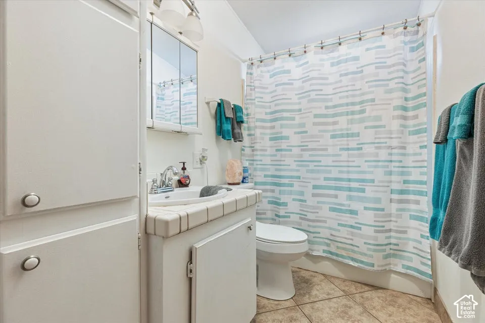 Vanity with integrated sink, tile countertop, and medicine cabinet