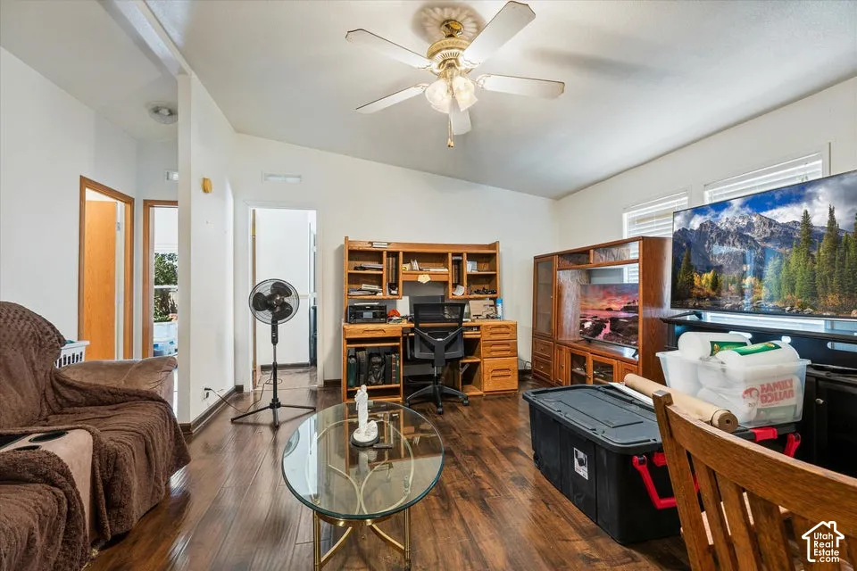 Sloped ceilings complement wood-finish flooring, featuring a ceiling fan with integrated lighting