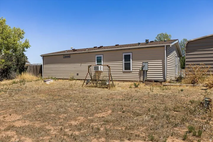 Exterior featuring horizontal siding, multiple windows, and a side-entry door
