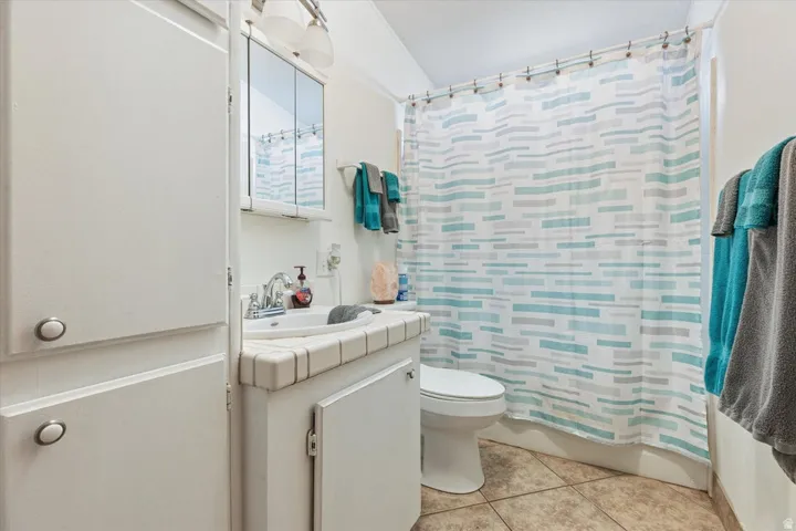 Vanity with integrated sink, tile countertop, and medicine cabinet
