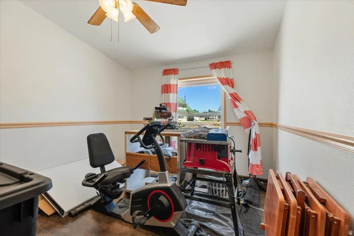 Recessed window with wood trim, ceiling fan, and chair rail molding