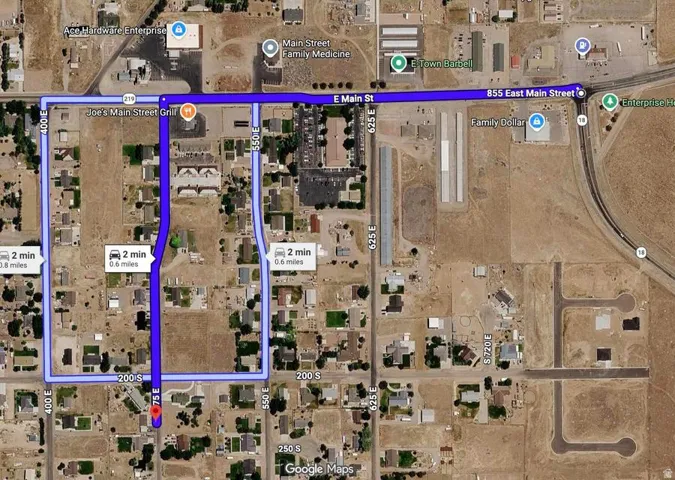 Satellite Map. Displaying a route calculation with distance and estimated travel time, indicating various street names and commercial establishments