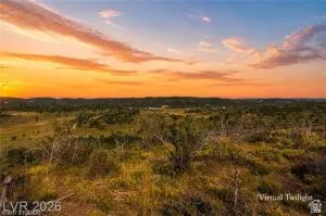 Expansive undeveloped land featuring varied terrain and natural vegetation, set against a wide-open sky